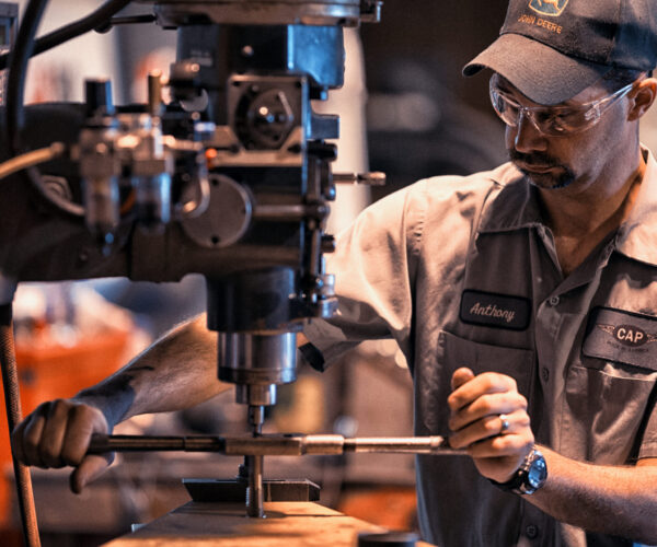 Man works on machinery in manufacturing setting