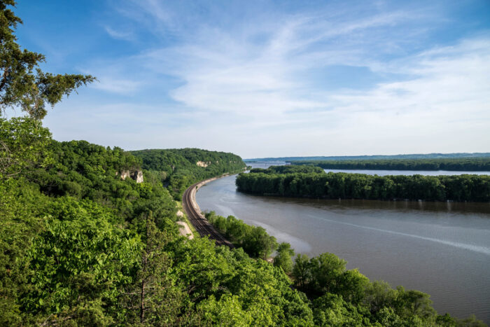 Mississippi River surrounded by railroad track and trees